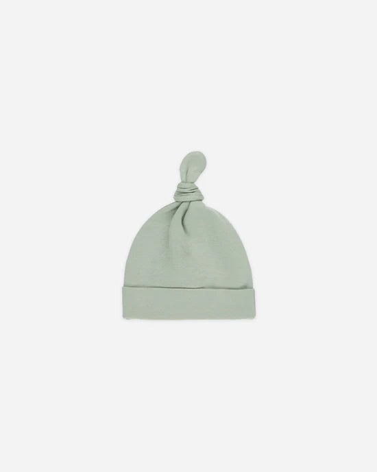 Soft stretchy organic cotton newborn hat with a knotted top in sage green, designed for delicate newborn heads. Machine washable fabric ensures easy care for busy parents.