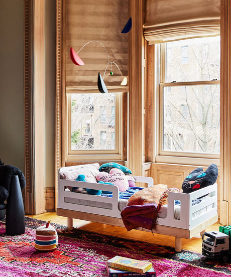 Classic toddler bed with low profile and safety rails, perfect for toddlers transitioning from a crib
