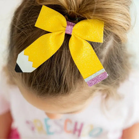  Kids’ hair bow clip by Coquette featuring pencil design, perfect for back-to-school
