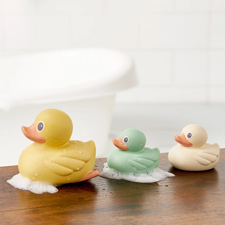 Three soft squeezable bathtub ducks in modern pastel colors, designed with water-tight seals to prevent mold growth. Ideal for interactive pouring games in baby baths or outdoor water tables.