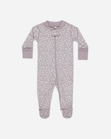 Soft 100% organic cotton baby footie with full-body zipper and lavender ditsy floral print. Includes fold-over mittens (sizes NB-6M) and anti-slip rubber soles (6-18M). Machine-washable for easy diaper changes.