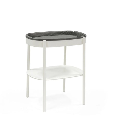Stokke Sleepi Changing Table – sleek wooden diaper changing station with open storage shelves and soft curved edges for modern nurseries.